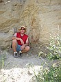 Steve Wagner next to a fossil tree trunk buried in its upright, growing position (in-situ).  Paleocene, D1 Sequence.