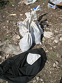 Cave material was placed in trash bags, then enclosed in these white tie bags.  These bags were placed inside the black canvas bags and attached to the wench for extraction from the cave.