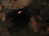 Looking from the end of the "big room" back to the smaller, lighted room where Jim Cornette was working.  This is a large cave and this image should give you the perspective necessary.