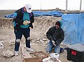 Shirley Alvarez (left) & Steve Wallace (right) wrapping and marking specimens.  The weather was getting colder and colder as the day went on.  Even though we tried, it's nearly impossible to wrap, tape & record specimens with gloves on!  (4/23/03)